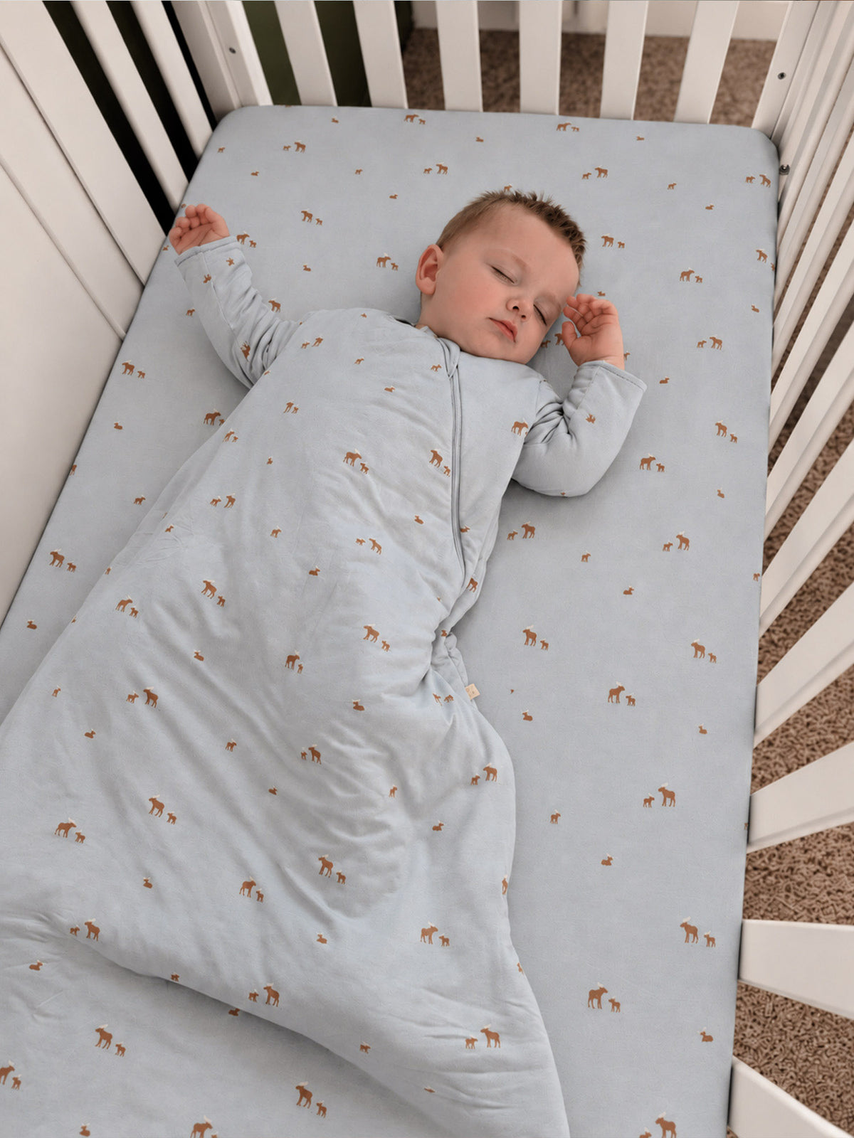 Light blue long-sleeve sleep sack with repeating moose pattern and full-length zipper