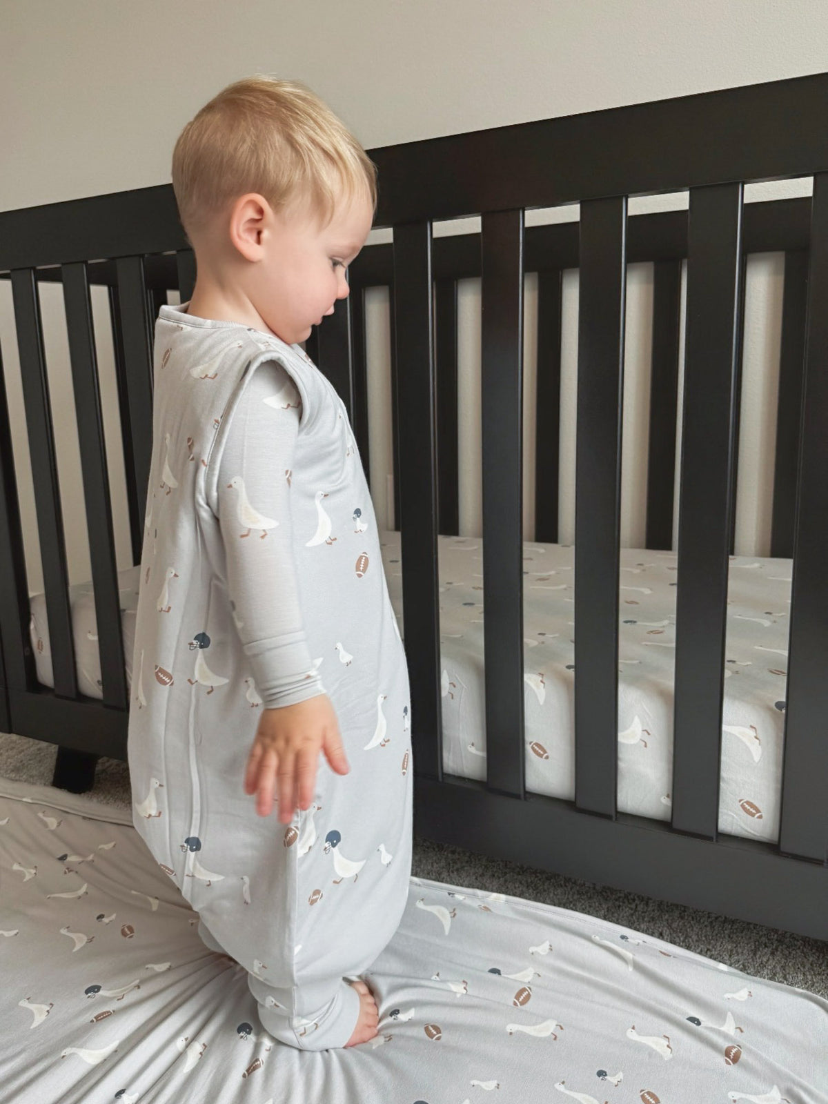 Kids footie sleep sack, light gray with football and goose prints, one-piece legs
