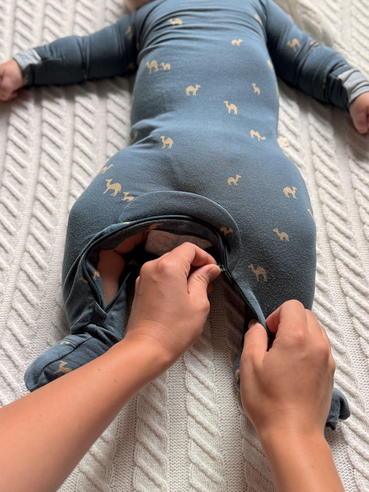 Navy camel-print footed pajama romper, toddler partially opens foot opening