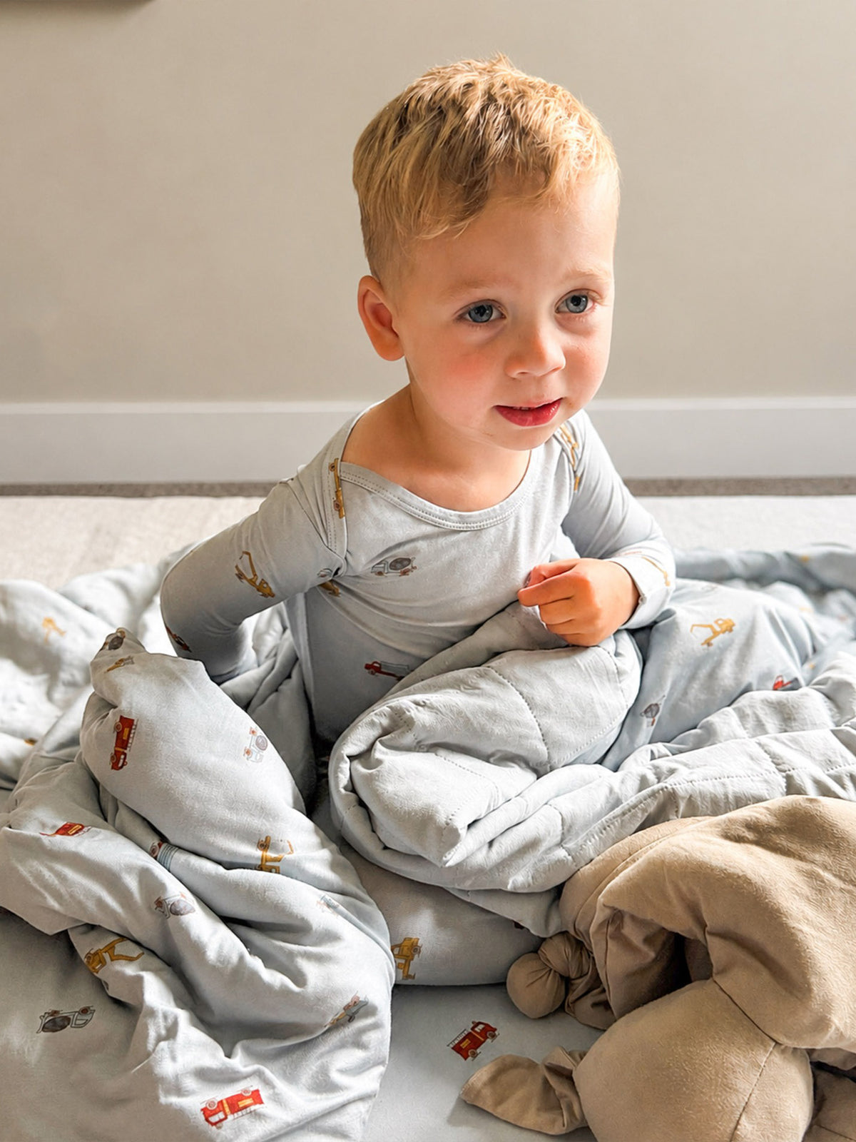 Light blue 2.5 TOG blanket with vehicle print, folded wrap around baby