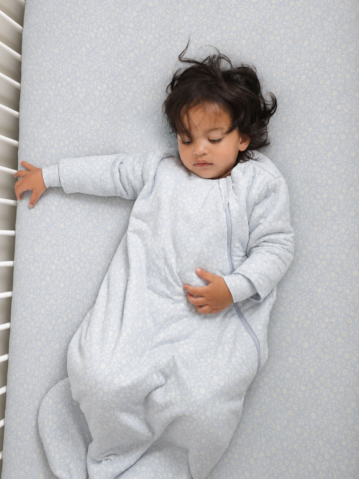 Light blue long-sleeve sleep sack with small white print and full-length zipper