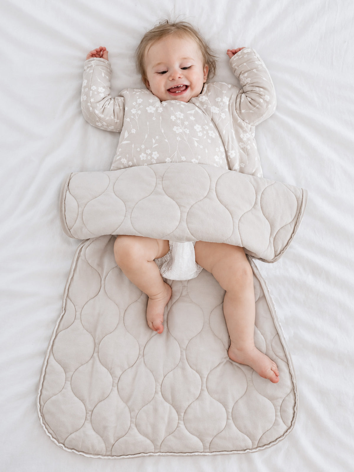 Baby sleep sack with light beige floral print and long sleeves