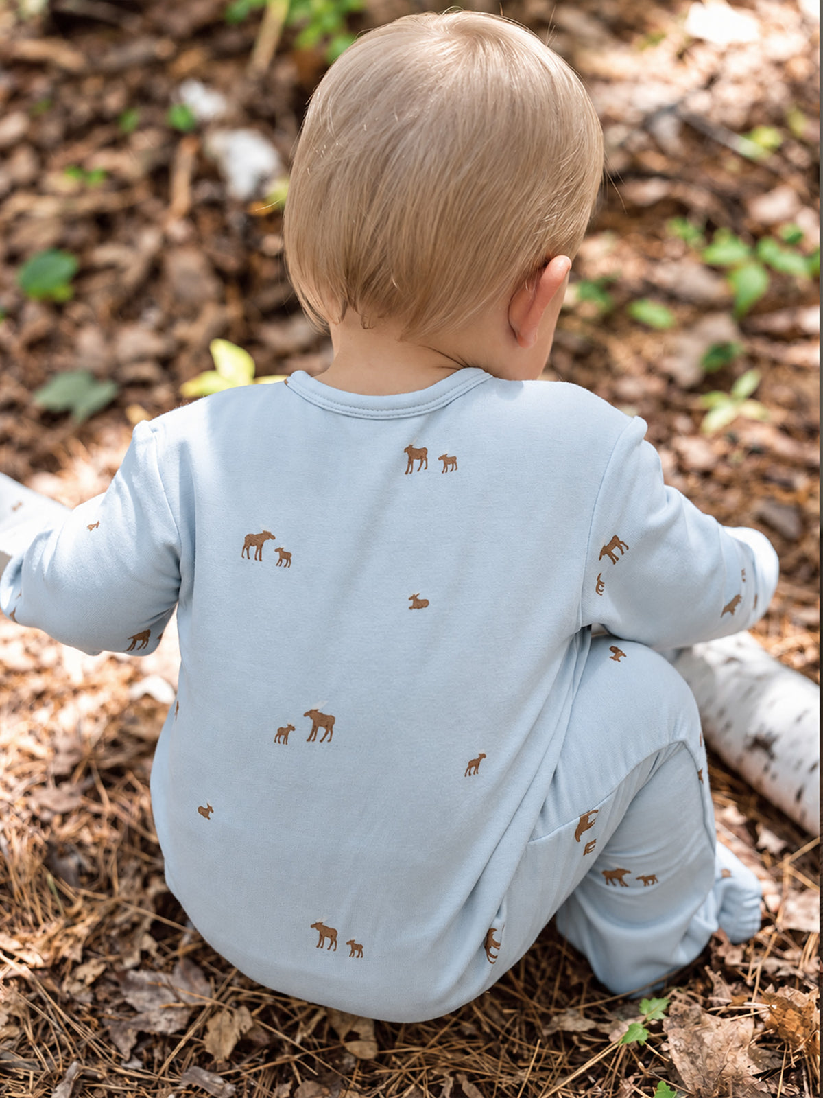 Light blue baby henley jumpsuit with long sleeves and scattered moose print, back