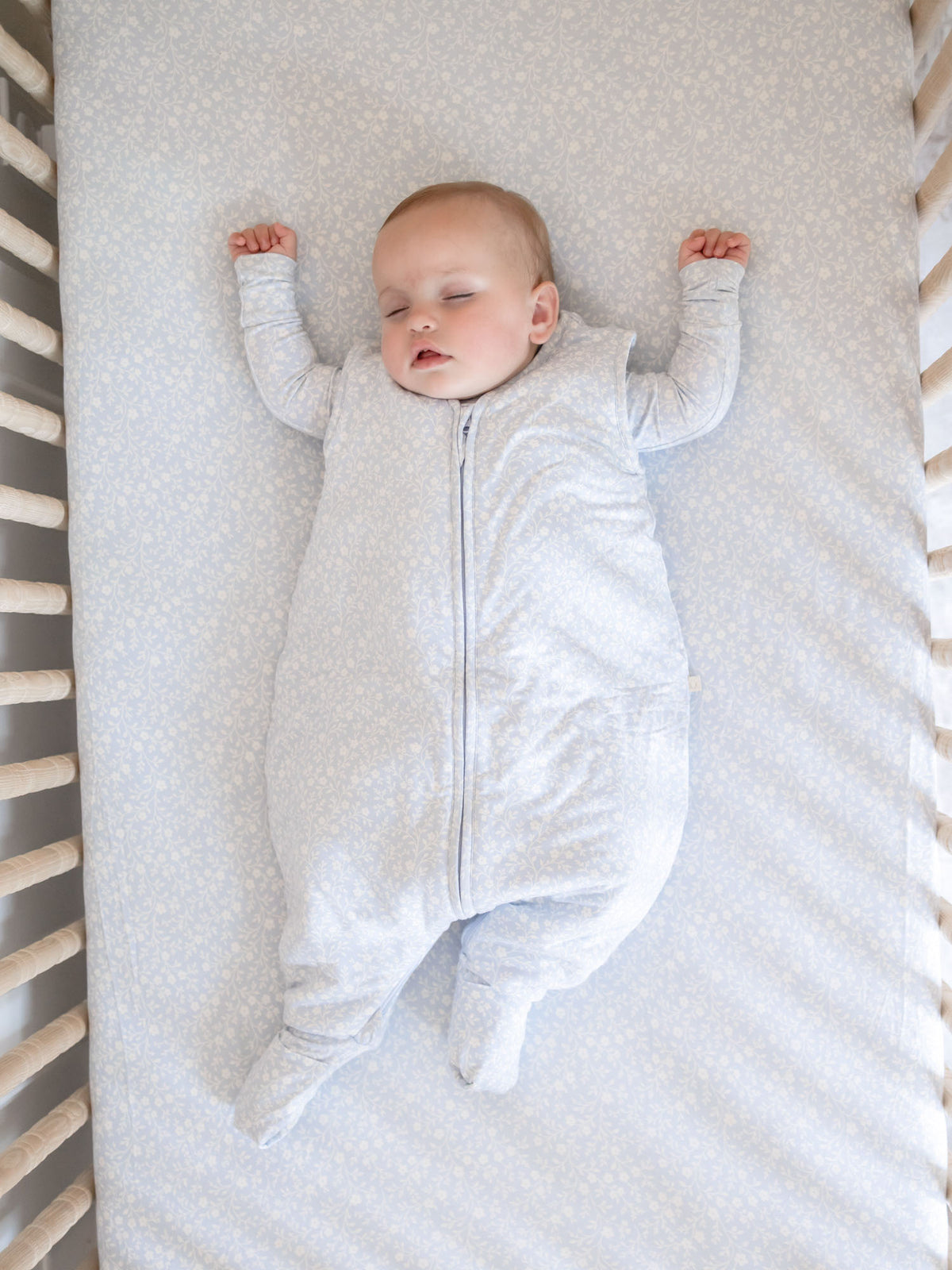 Light blue patterned footie sleep sack with long sleeves and center front zipper