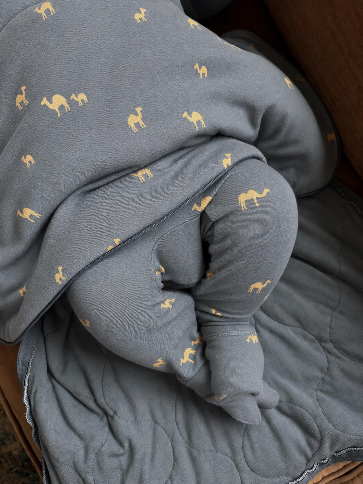 1.0 TOG sleep sack in slate blue with camel print, close-up of wrap and lining