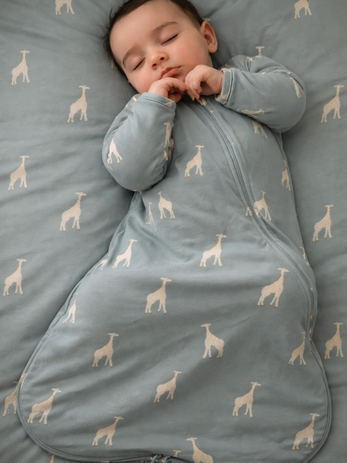 Moss green long-sleeve sleep sack with giraffe print, zip front and wrap-around bottom