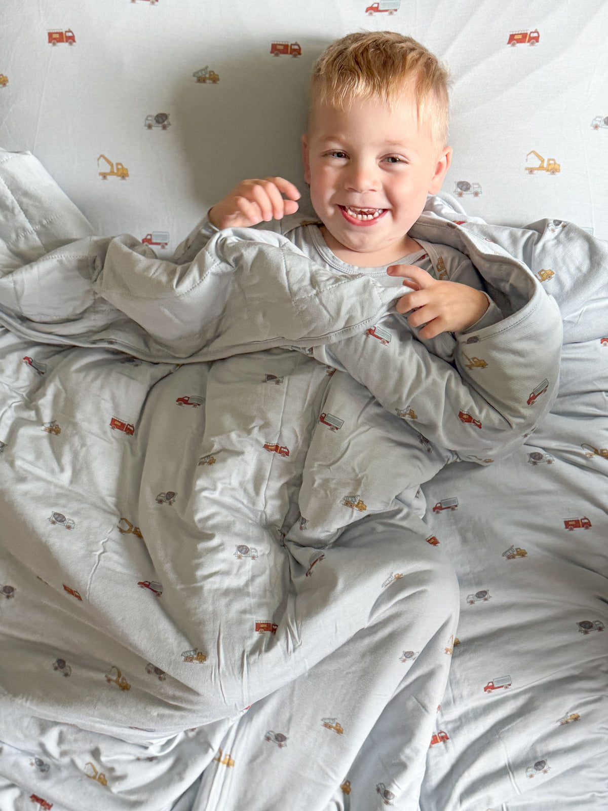Light blue 2.5 TOG blanket with detailed vehicle print, soft gathered folds