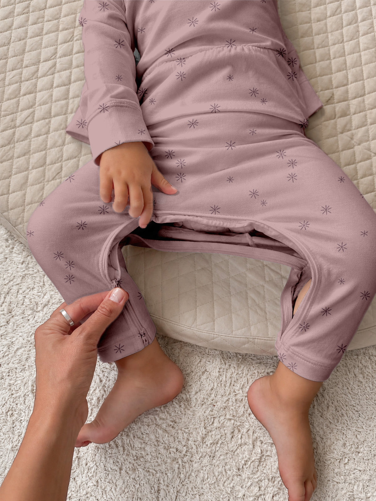 Lilac printed fleece set close-up, adult adjusts toddler leggings and cuffs