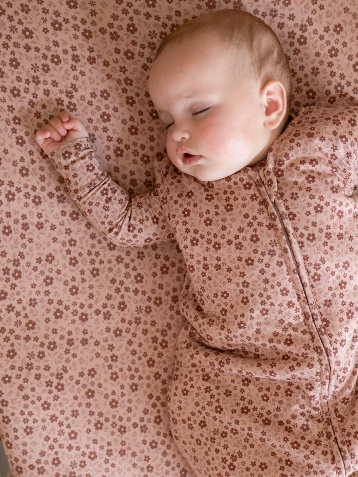 Blush pink floral footed sleep sack with long sleeves and zip-front closure, TOG 1.0.