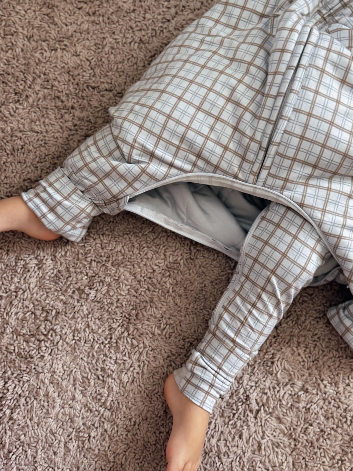 Footie sleep sack close-up: cream plaid 1.0 TOG with zip front and enclosed feet