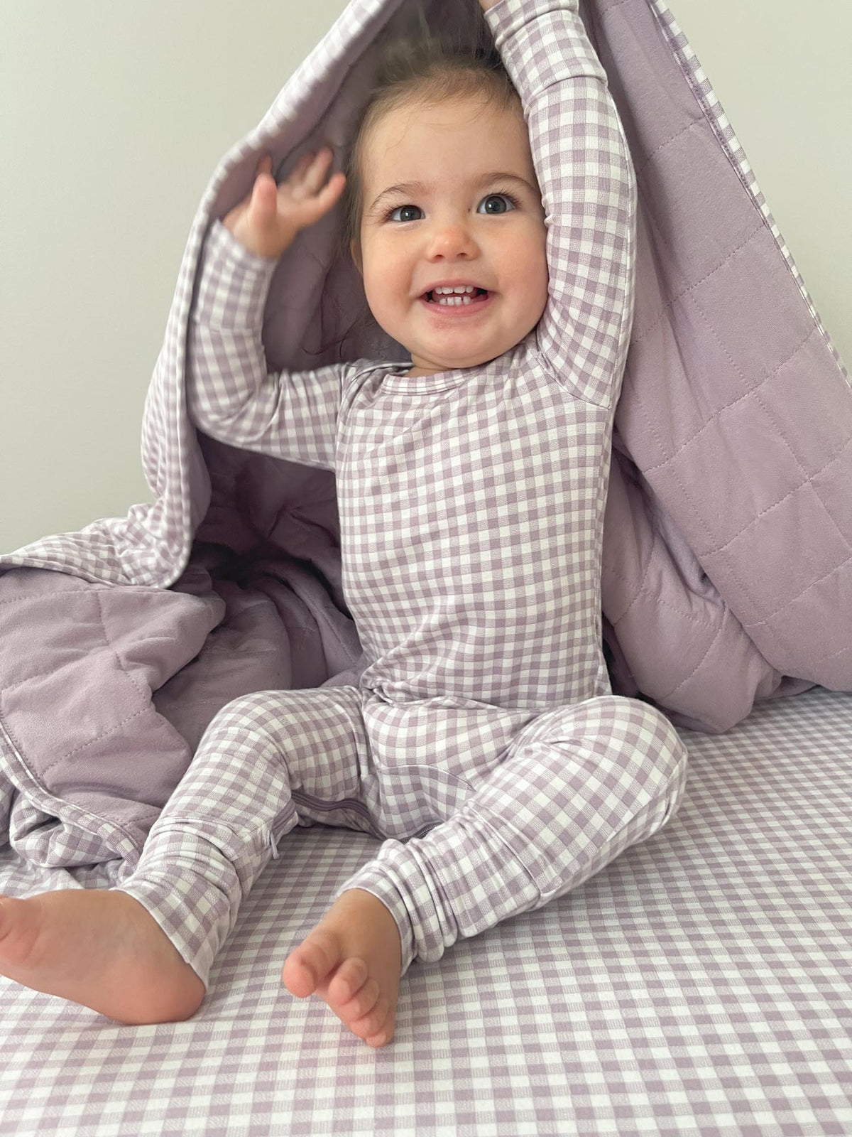 Gingham plaid baby pajama one-piece with long sleeves and footed legs