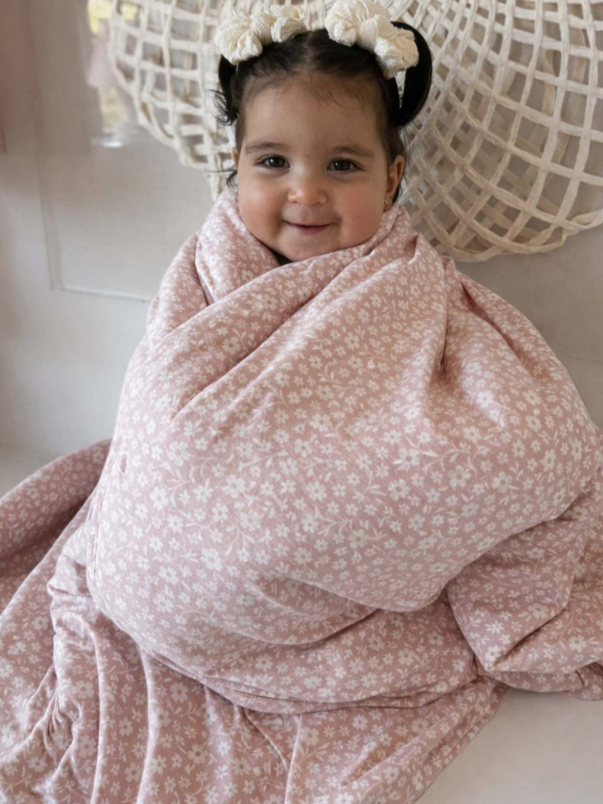 Pink floral baby blanket wrap with wide drape and satin-trim edge
