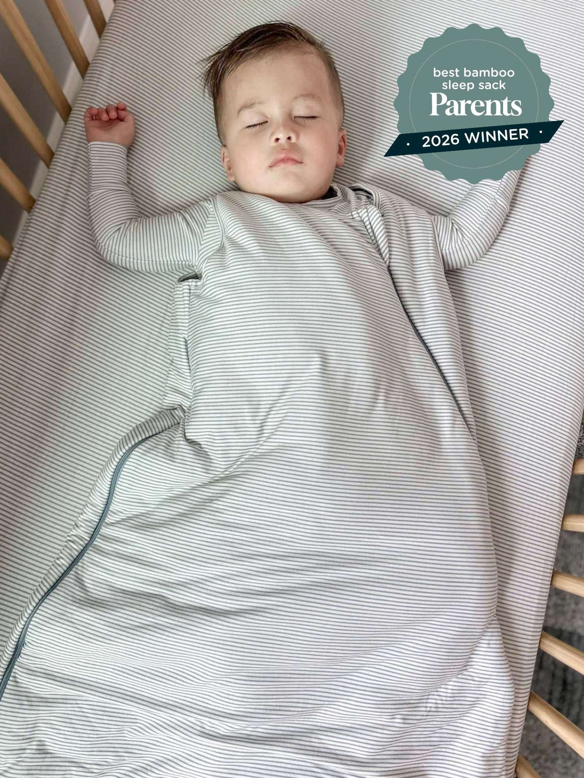 Blue striped sleep sack with long sleeves and zipper, baby lying on back