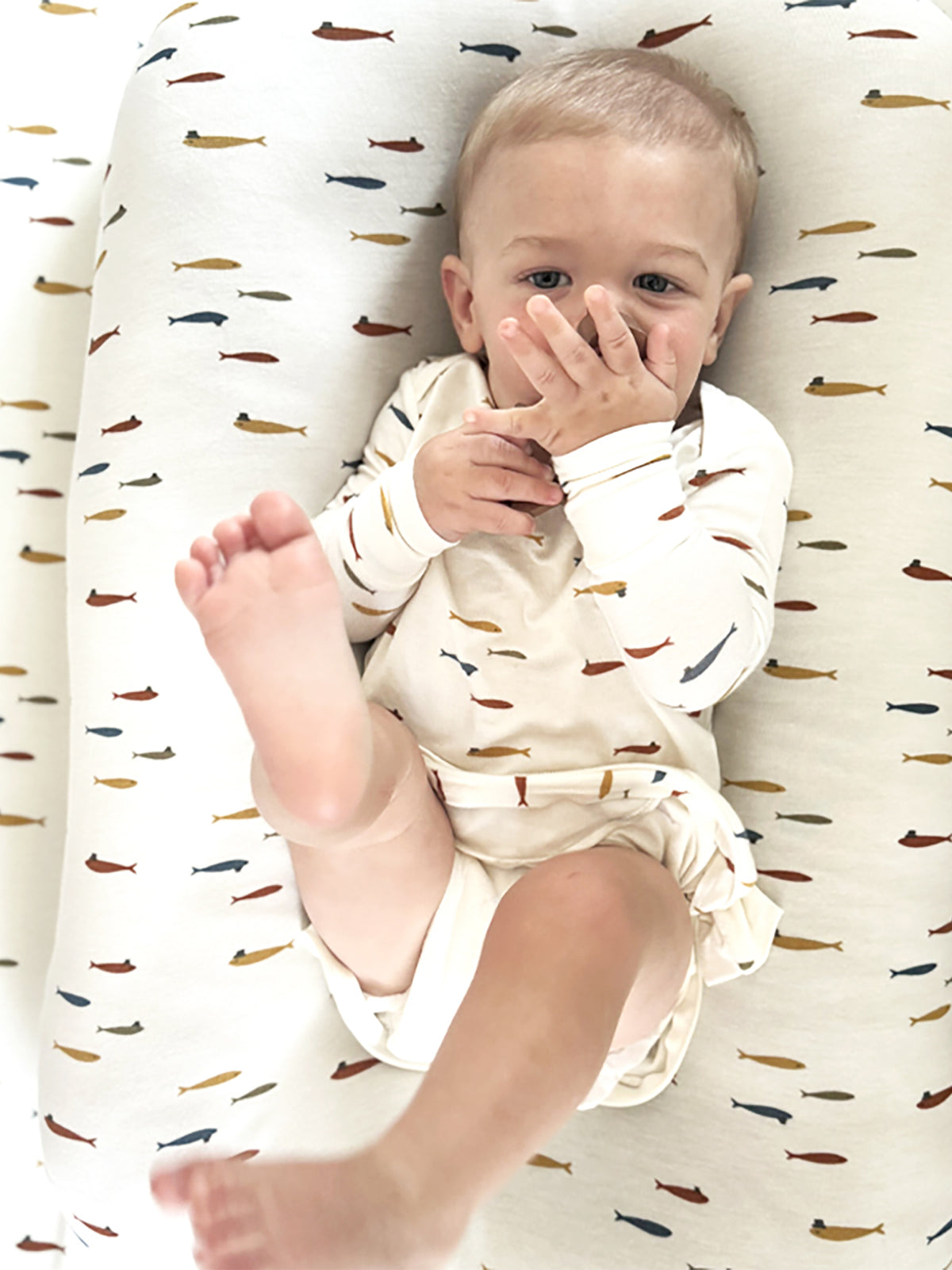 Fish-themed changing pad cover, cream with all-over fish and hat motifs