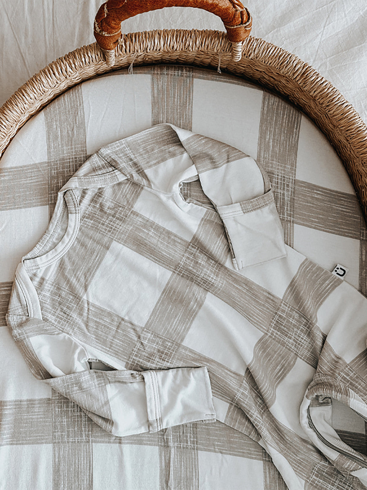 Changing pad cover in light gray and white plaid with layered wrap flap