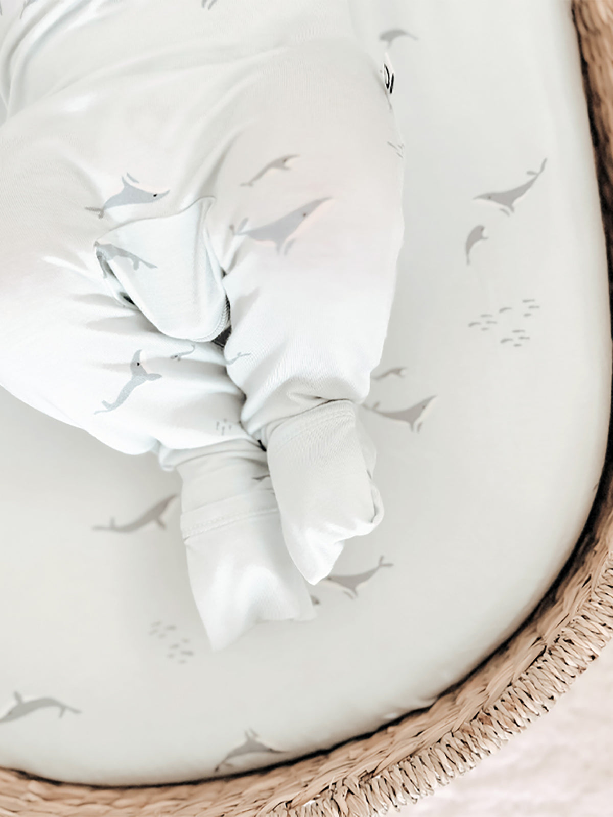 Changing pad cover detail, white fabric with gray whale print and snug fit