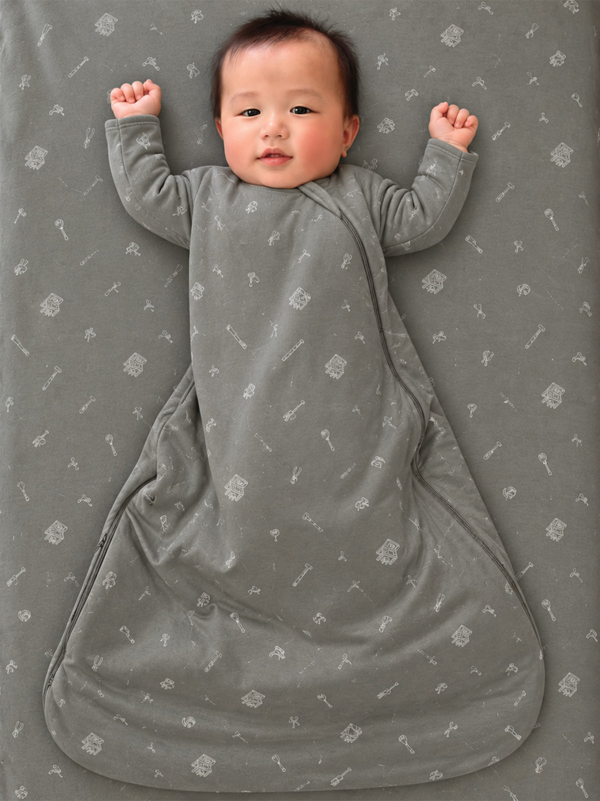 Gray long-sleeve sleep sack with allover tool print, covered feet and open armholes
