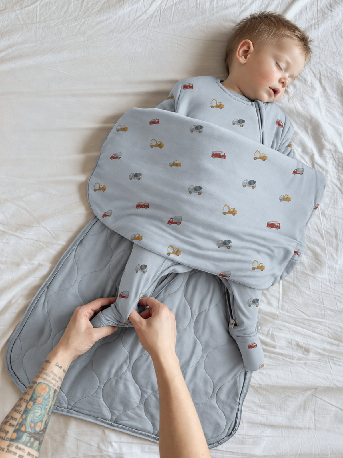 Light blue long-sleeve sleep sack with small vehicle print and front zipper