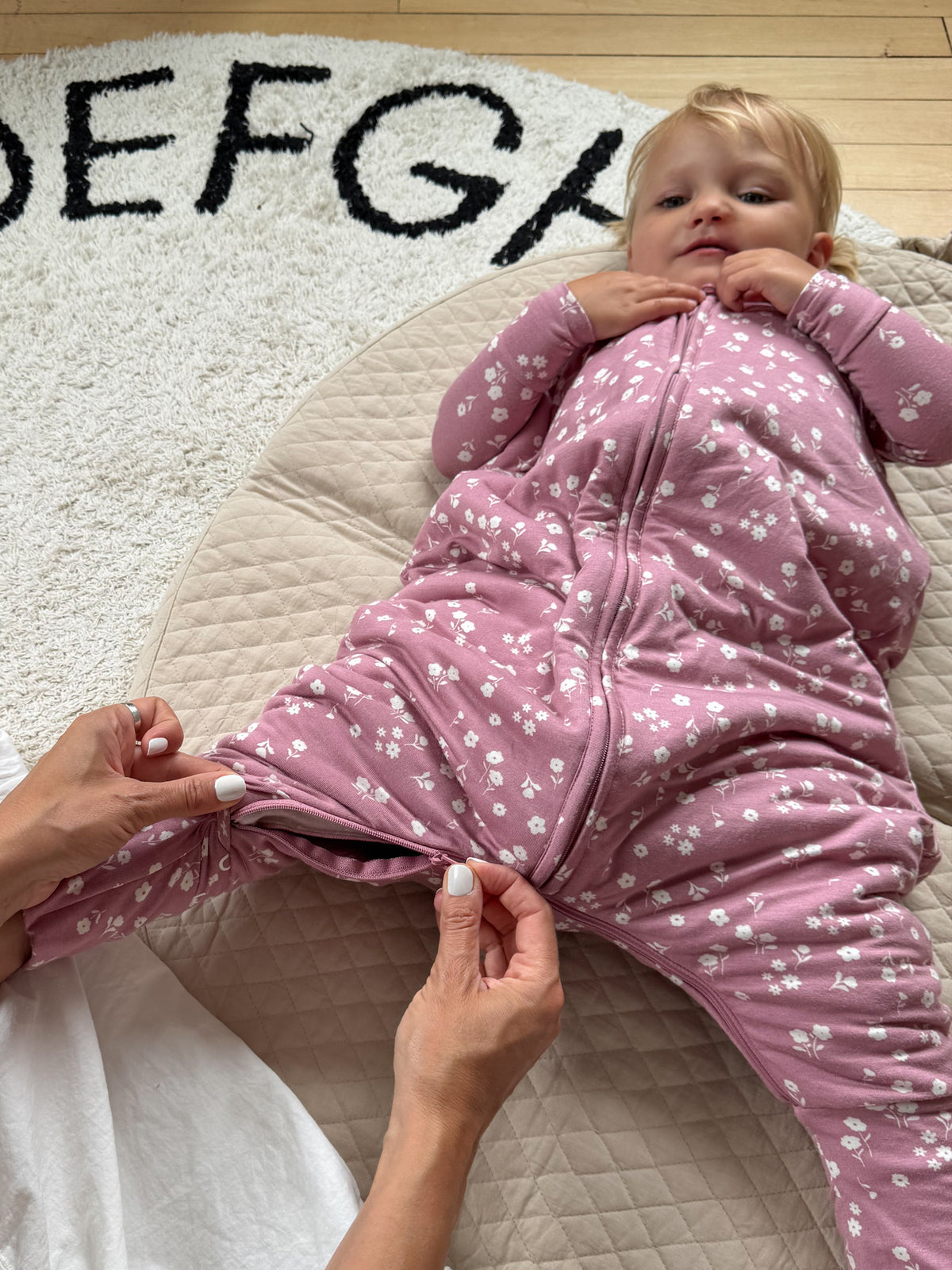 Mauve mini floral footie sleep sack with front zipper and mitten-style cuffs