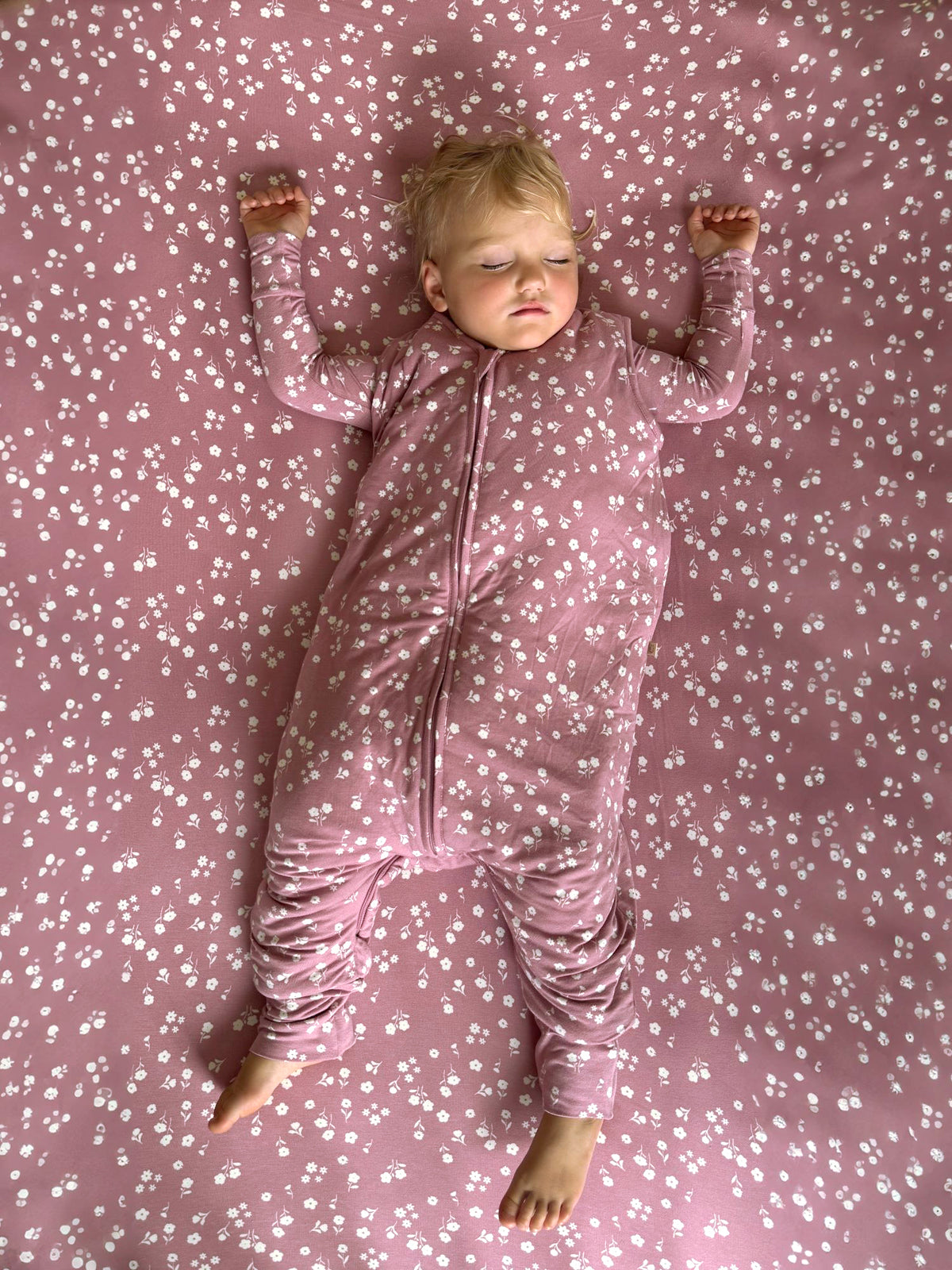 Mauve mini floral footie sleep sack with zip closure and long sleeves