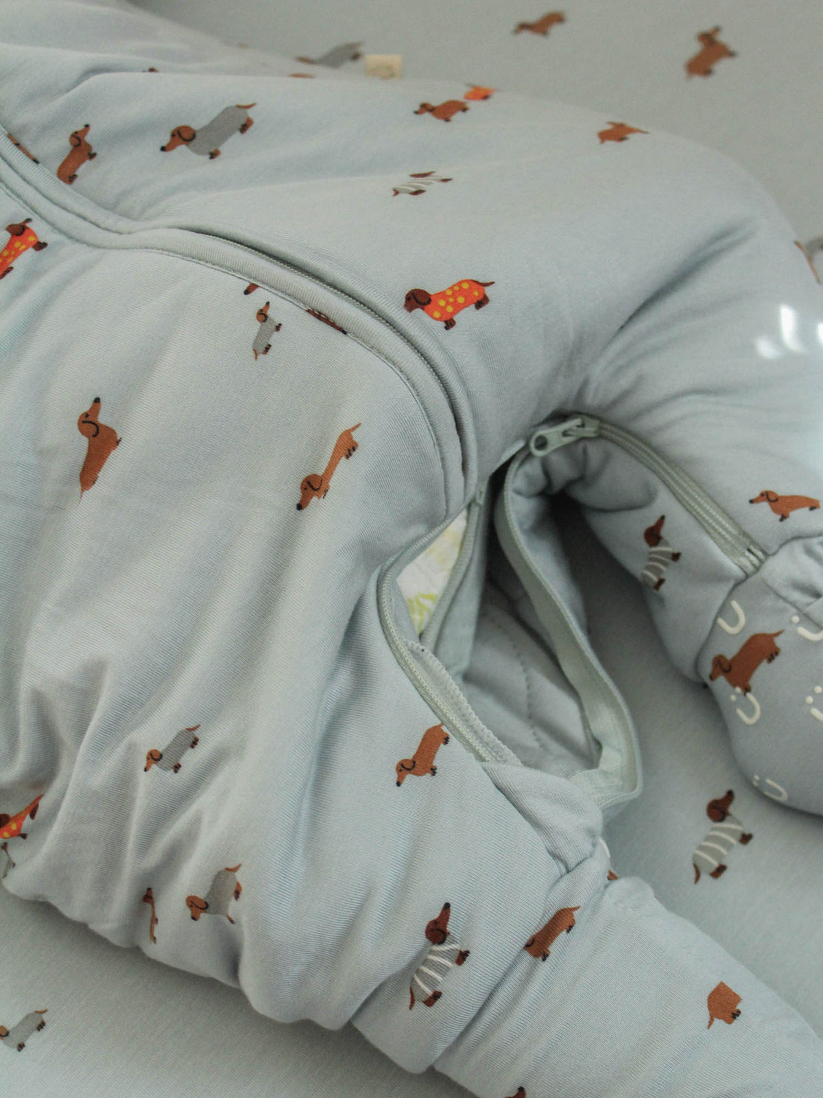 Light blue sleep sack with dog print, fold-over mitten cuffs and zipper