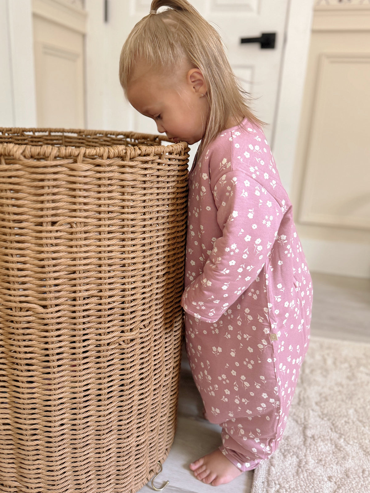 Long-sleeve footie sleep sack in dusty pink with mini white floral print