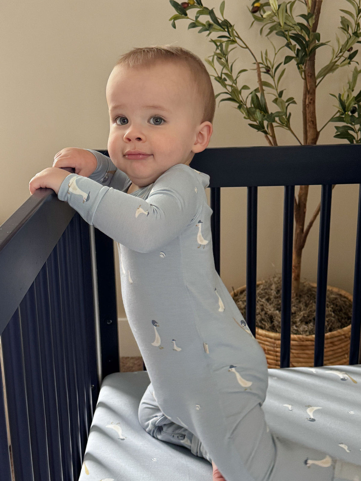 Light blue goose-print convertible baby pajama with long sleeves and button front