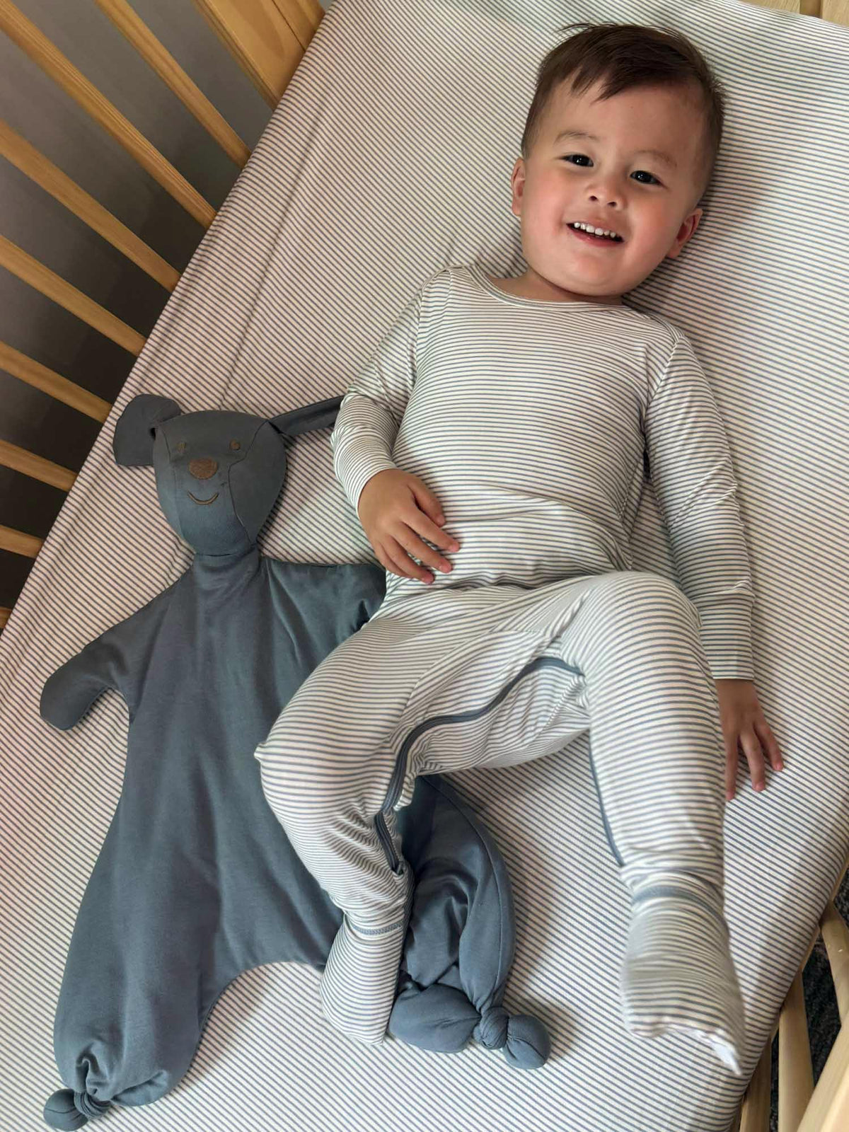 Blue-and-white striped convertible baby pajamas with long sleeves and relaxed pant legs