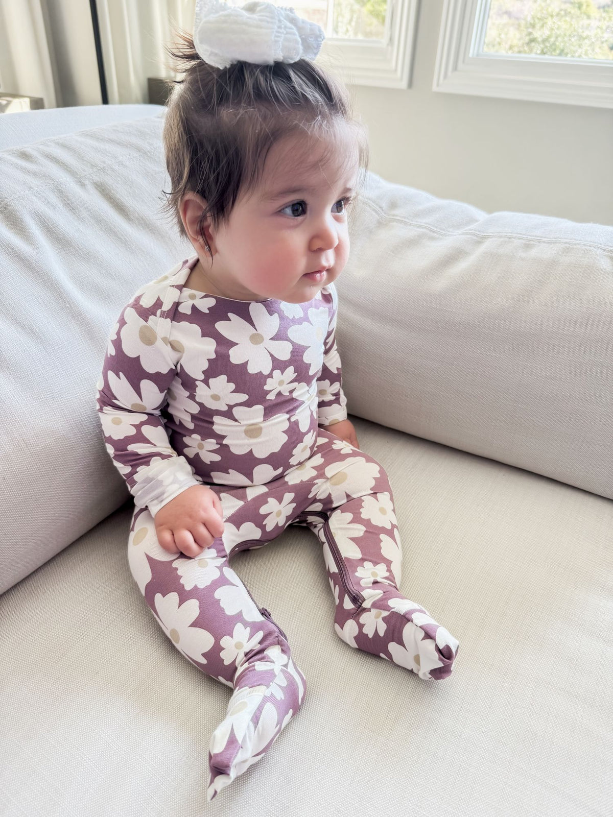 Maroon floral footed convertible pajamas with cream flowers; long sleeves, baby sitting