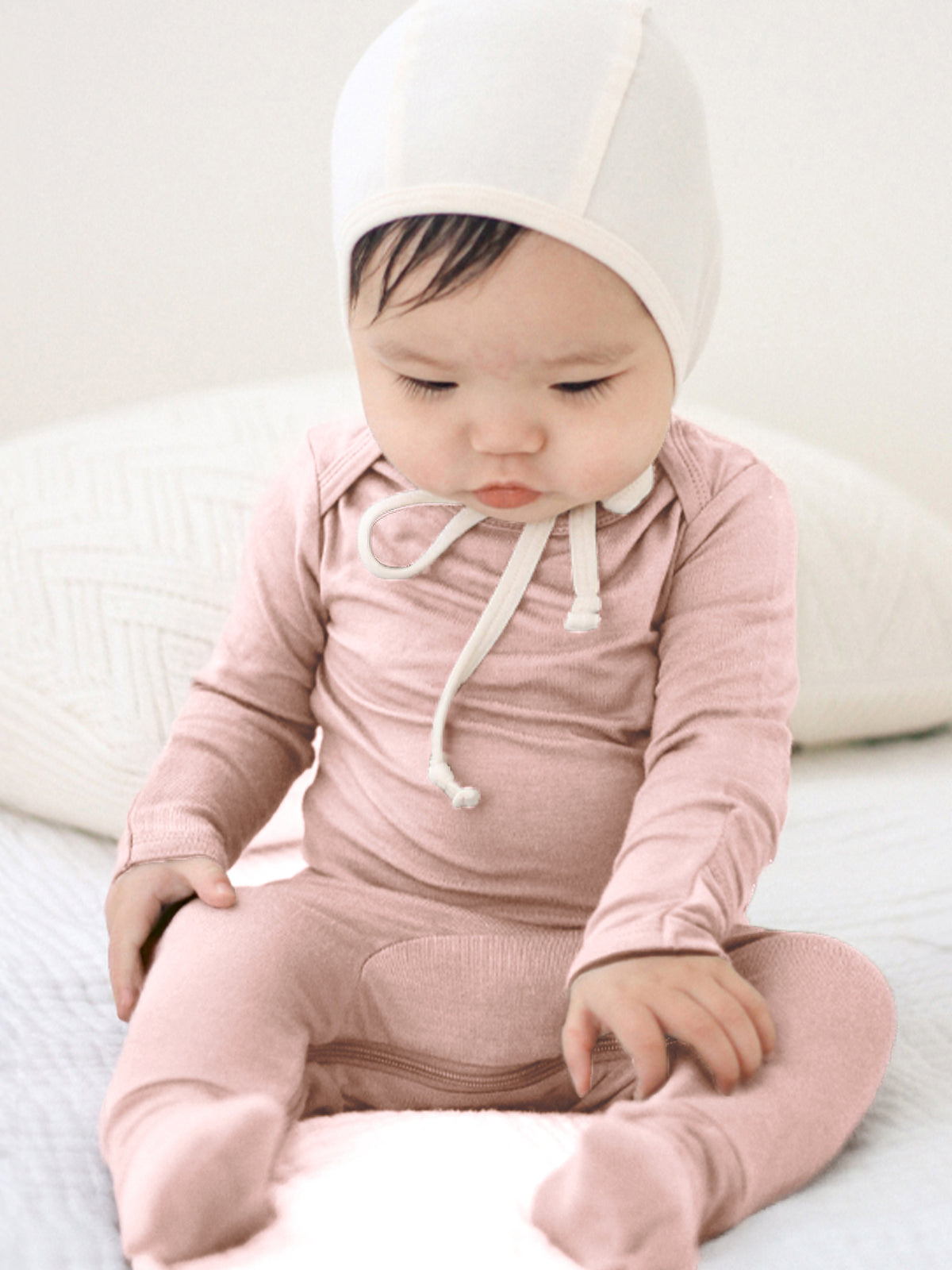 Pink hooded convertible pajama with white drawstring hood and front tie