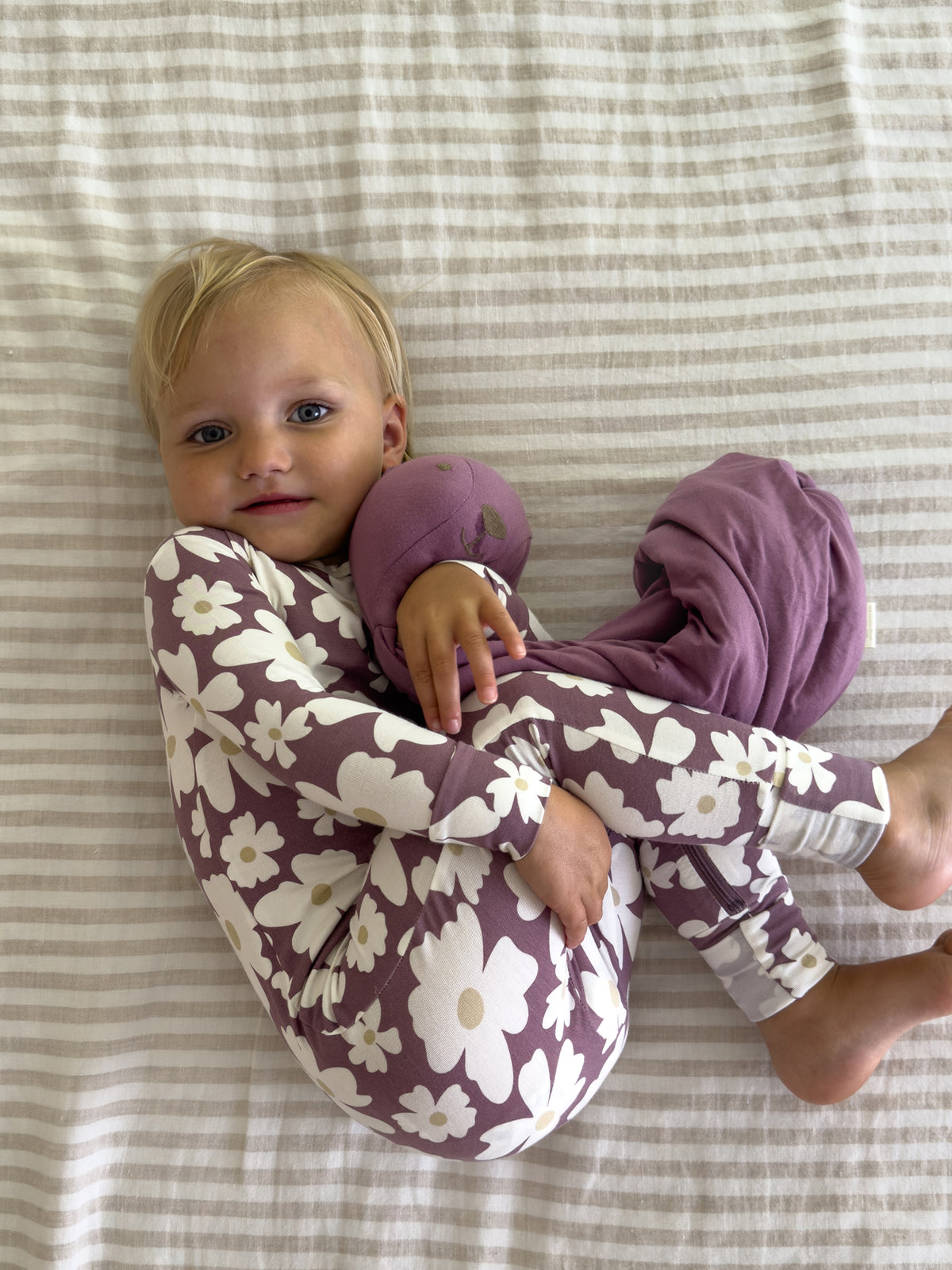 Maroon floral convertible pajamas with cream flower print; long sleeves and footed legs