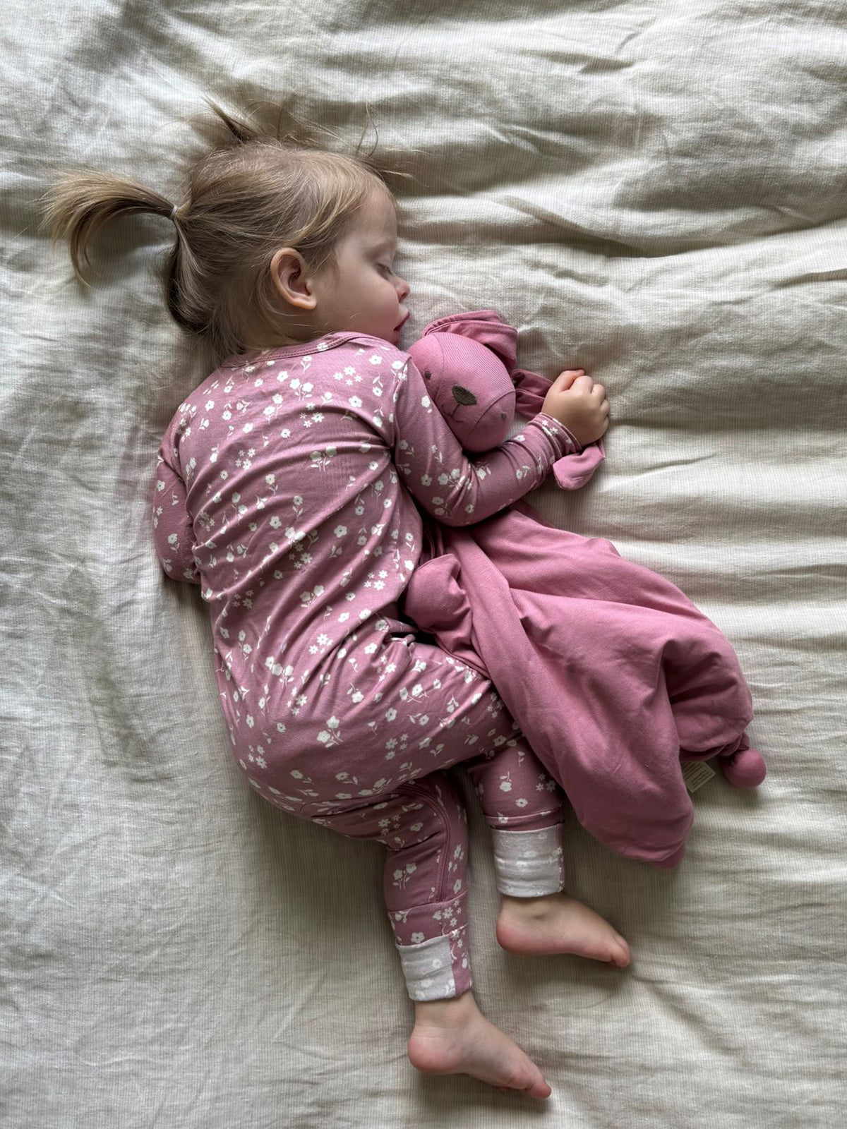 Pink mini floral convertible pajama with long sleeves, cuffs, and footed legs.