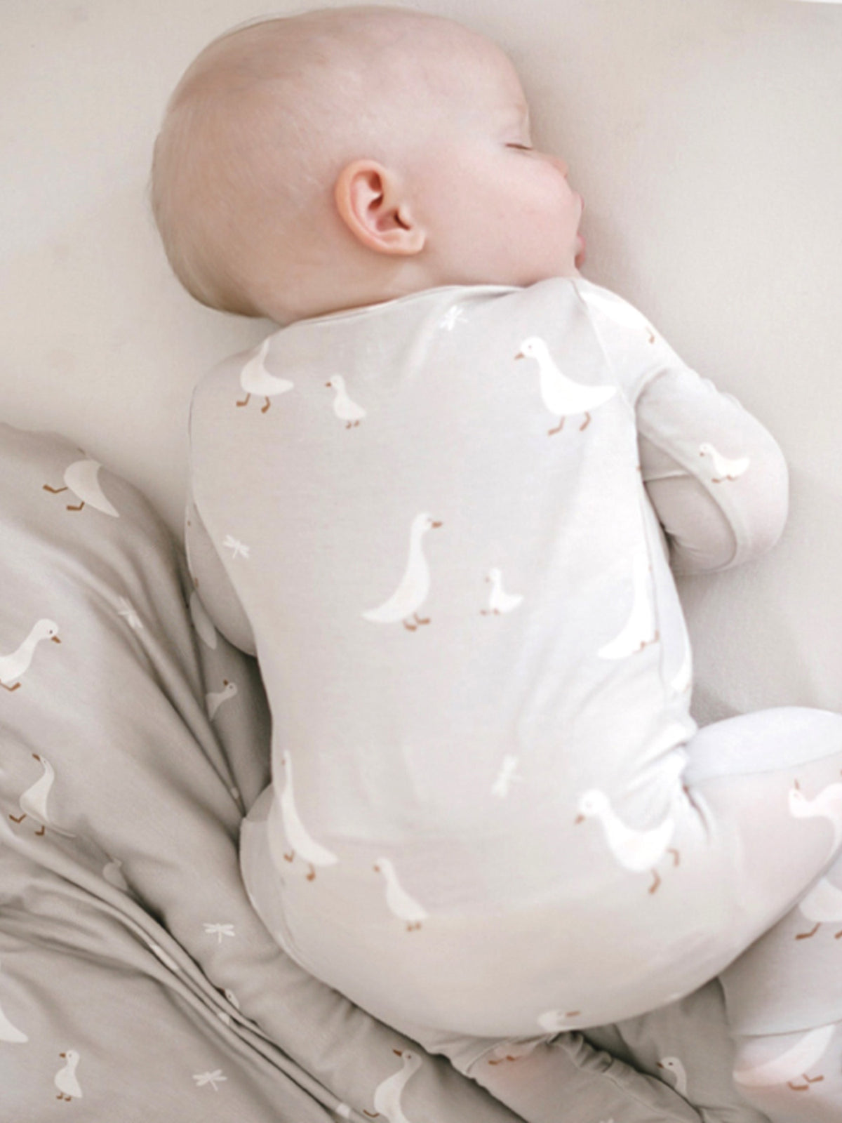 Light gray back view of goose-print convertible pajama with long sleeves