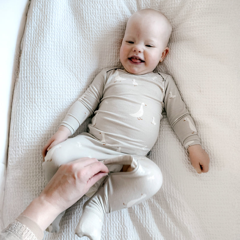 Light gray long-sleeve convertible pajama with allover goose print and footed legs