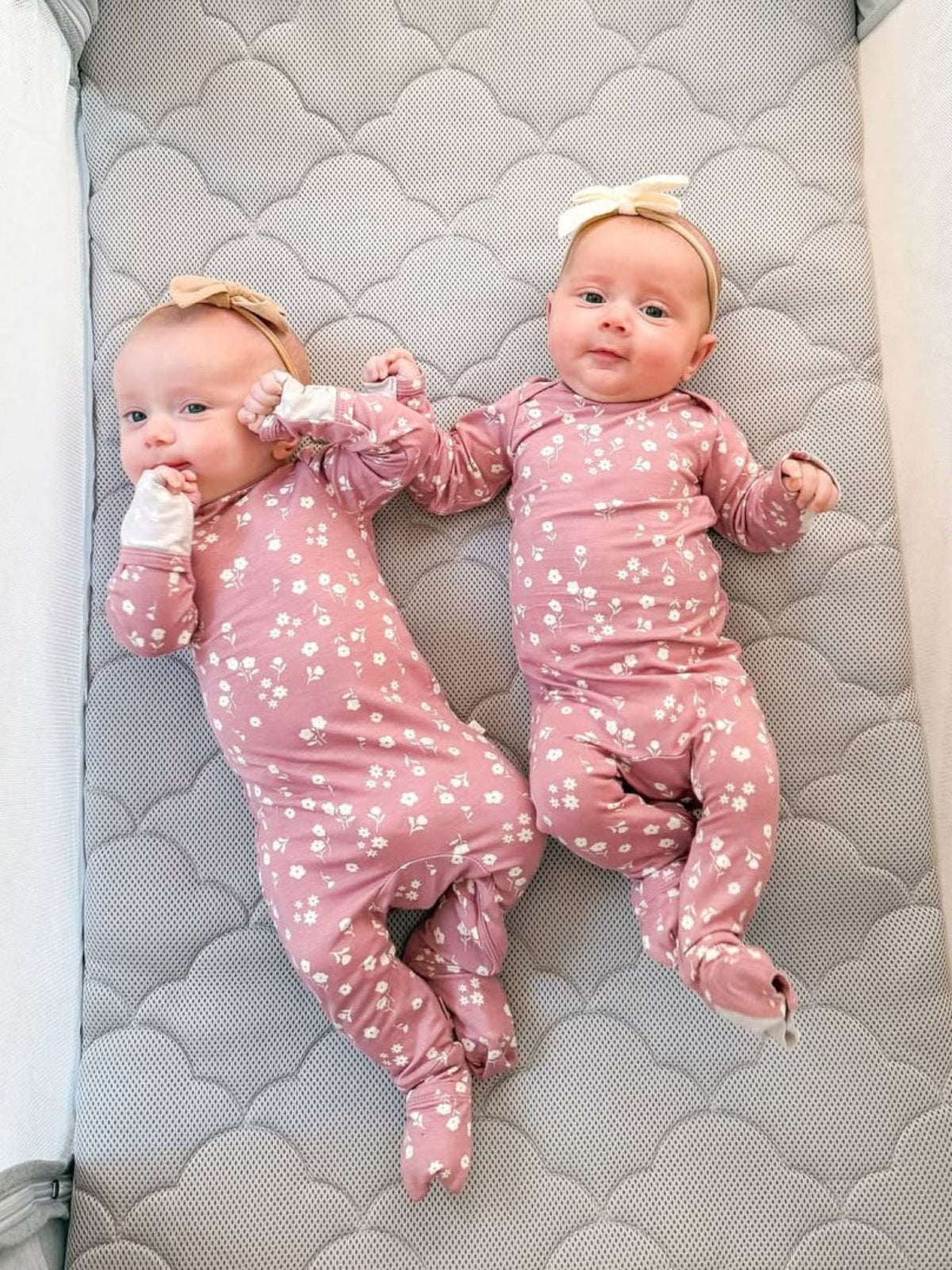 Pink mini floral convertible pajama with long sleeves and one-piece footed legs.
