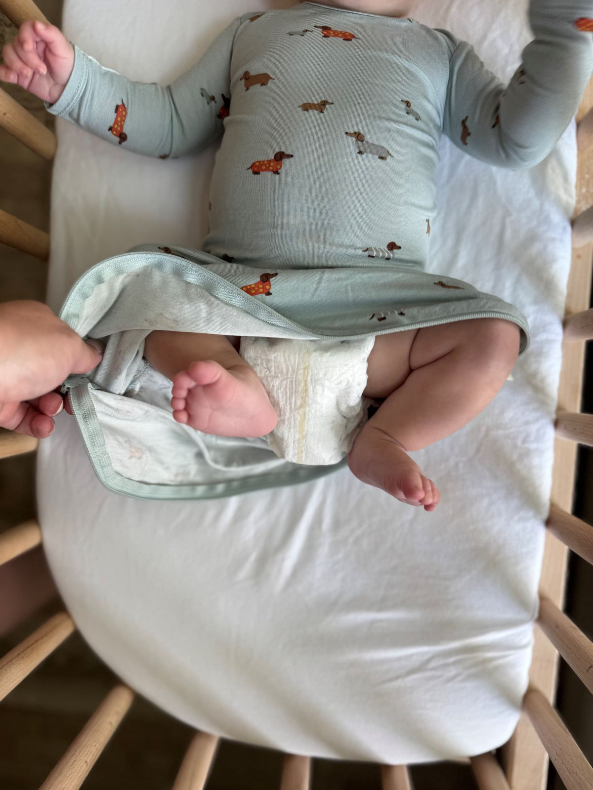 Baby gown in light blue with dog print, folded hem over a draped skirt