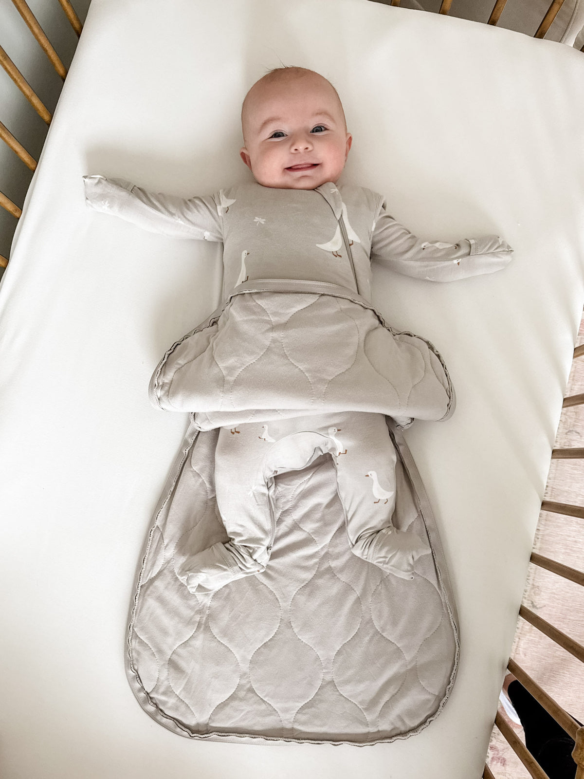 Transitional swaddle sleep sack, beige with white goose print, foldover blanket shape