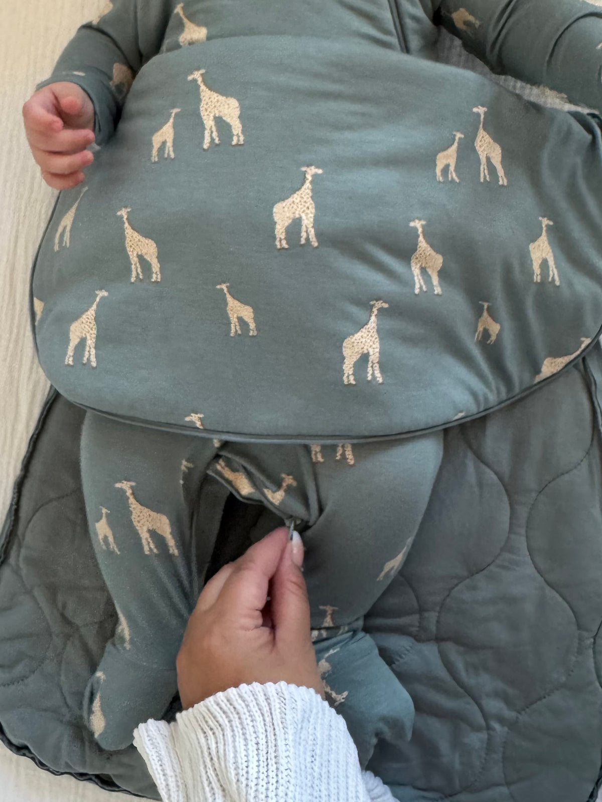 Moss green transitional swaddle sleep sack with giraffe print, zip front