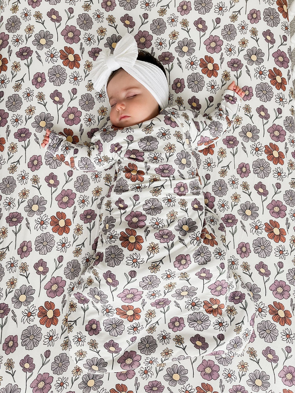 Long sleeve transitional swaddle sack with floral print, head opening and bow