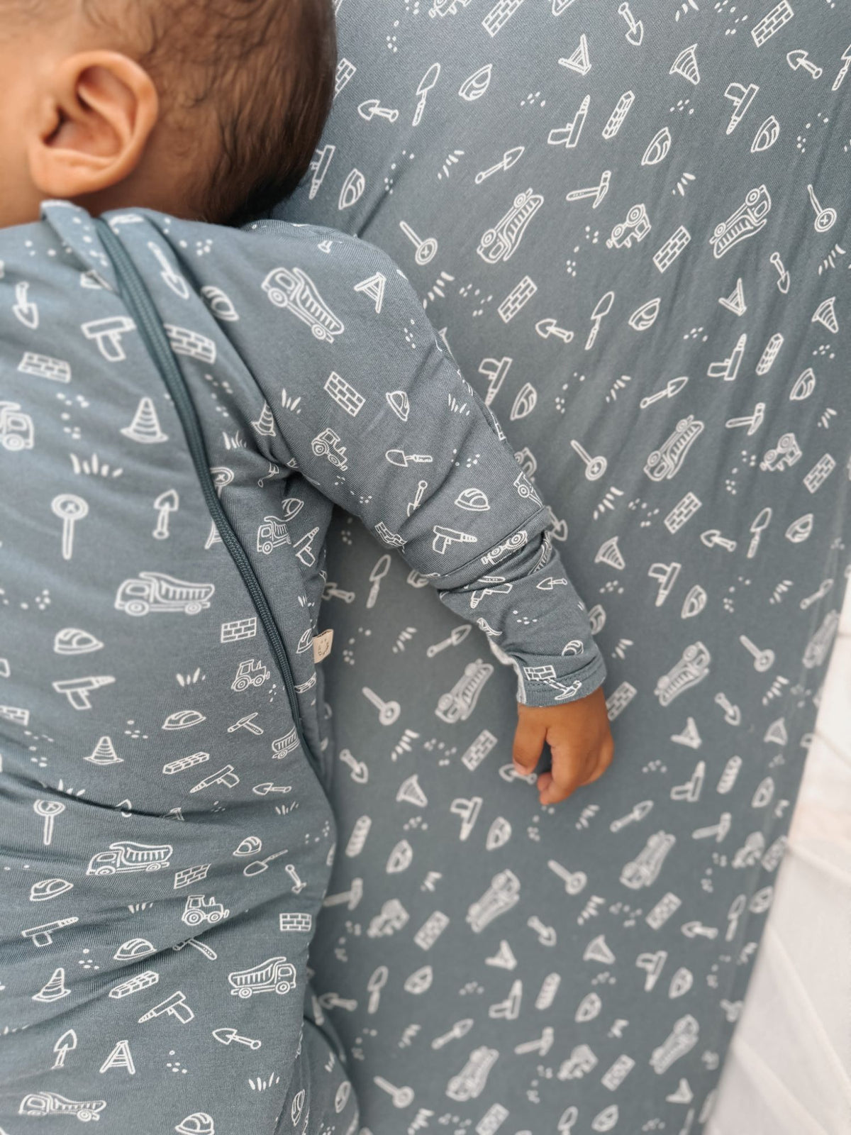 Long-sleeve swaddle sack, blue-gray with white instrument pattern and arm opening