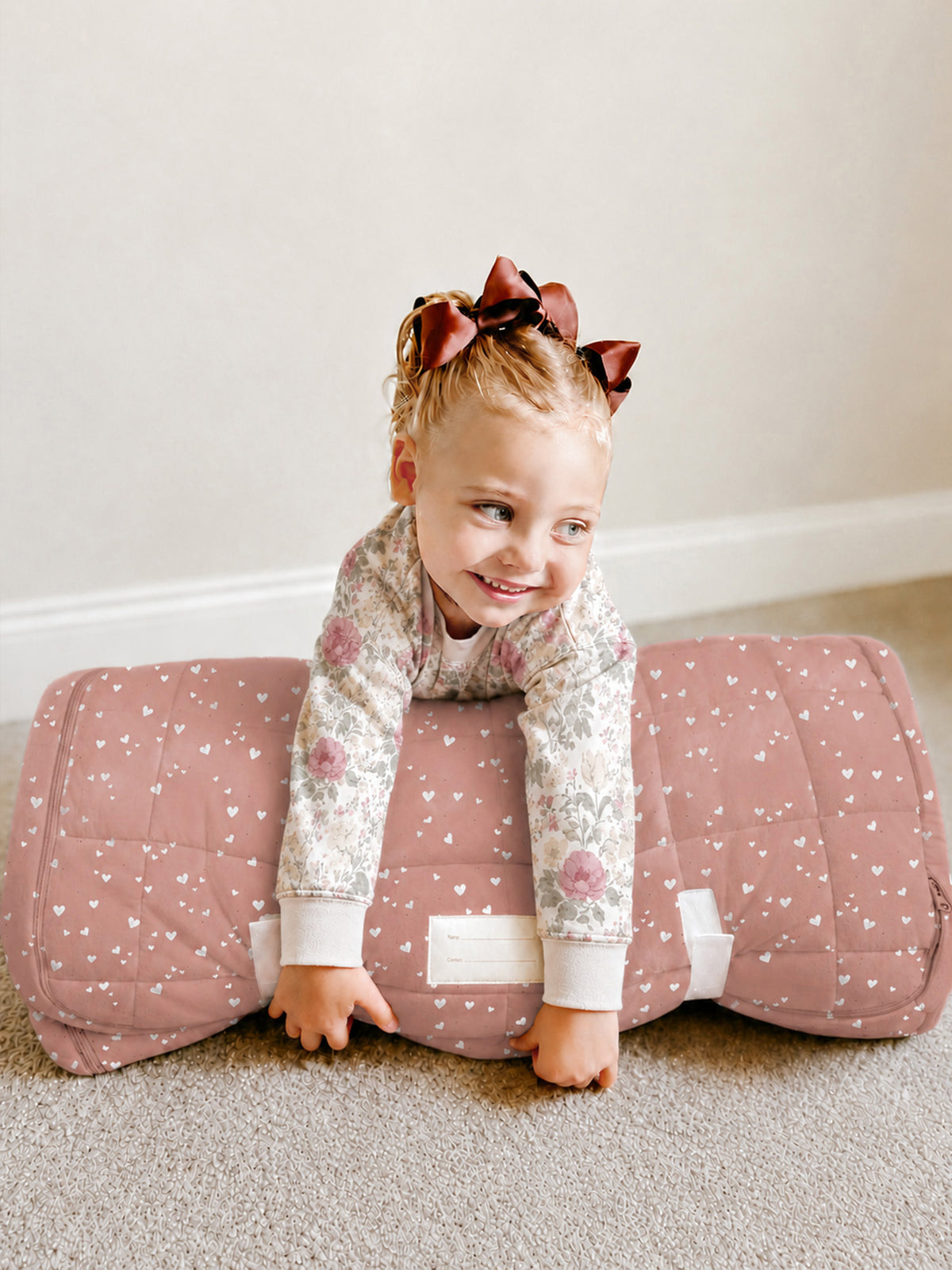 Hearts nap mat in dusty rose with small white heart pattern and folded ends