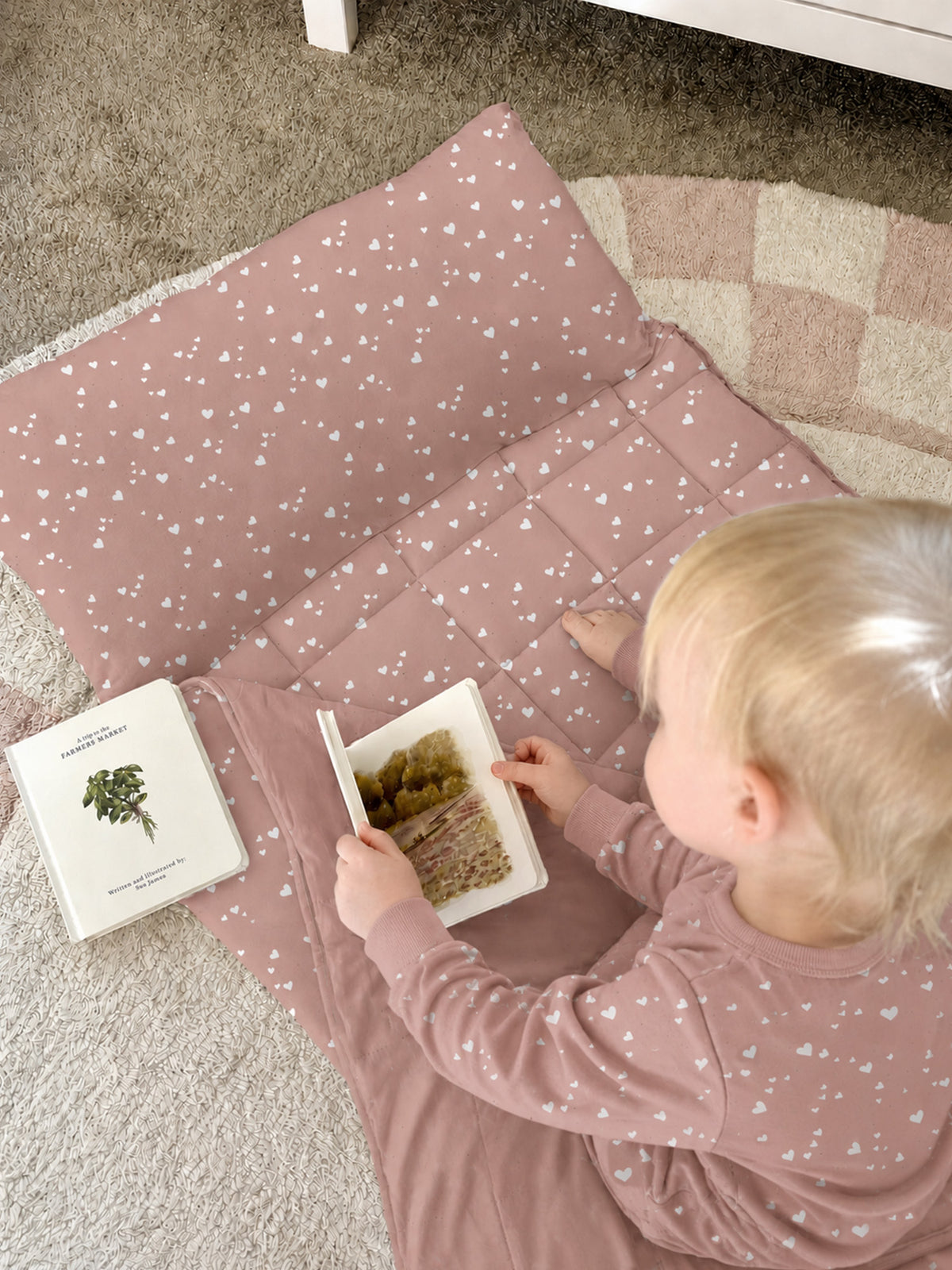 Hearts nap mat laid open with white heart print and soft padded interior