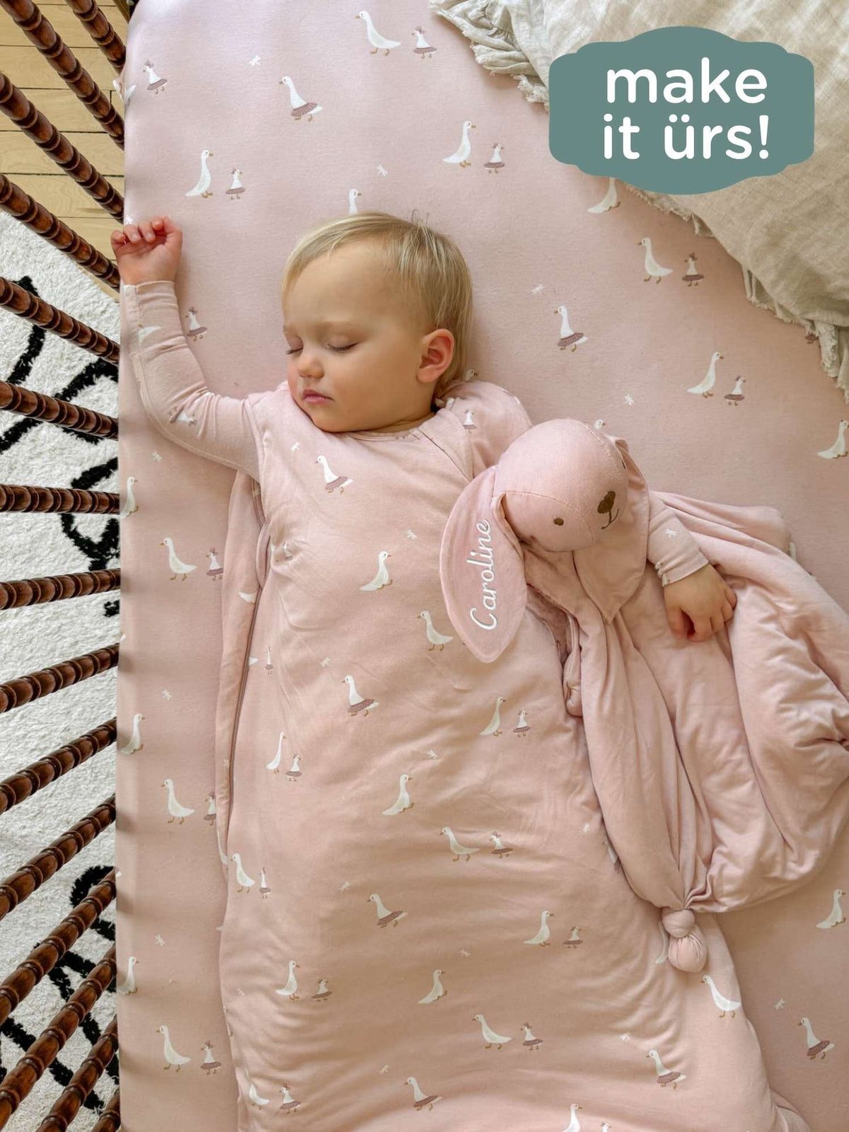 Pale pink bunny lovey with white bird pattern and plush bunny, child holding it