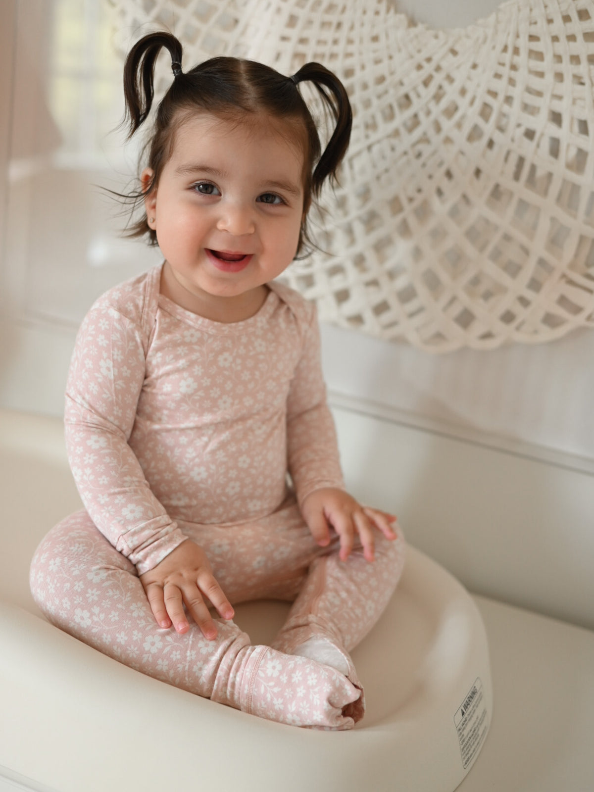 Blush pink floral pajama sleeper with long sleeves and closed footed legs