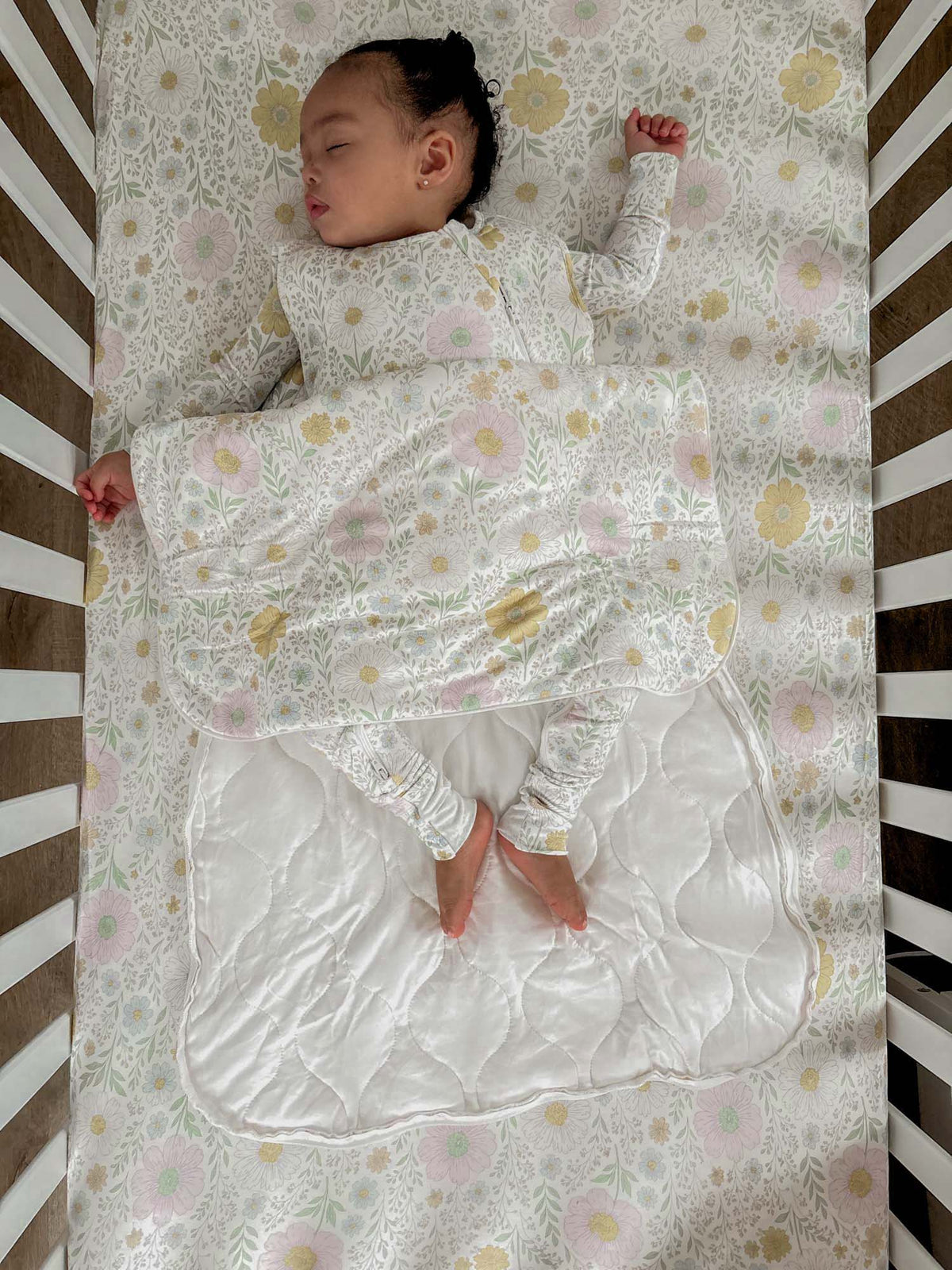 Pastel wildflower sleep sack displayed with ankle cuffs and long sleeves.