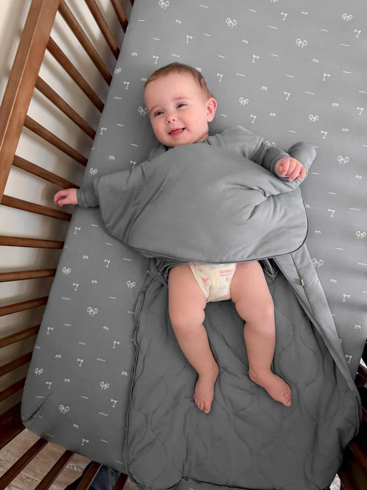 Gray zippered sleep sack with leg access for infants, 0.5 tog