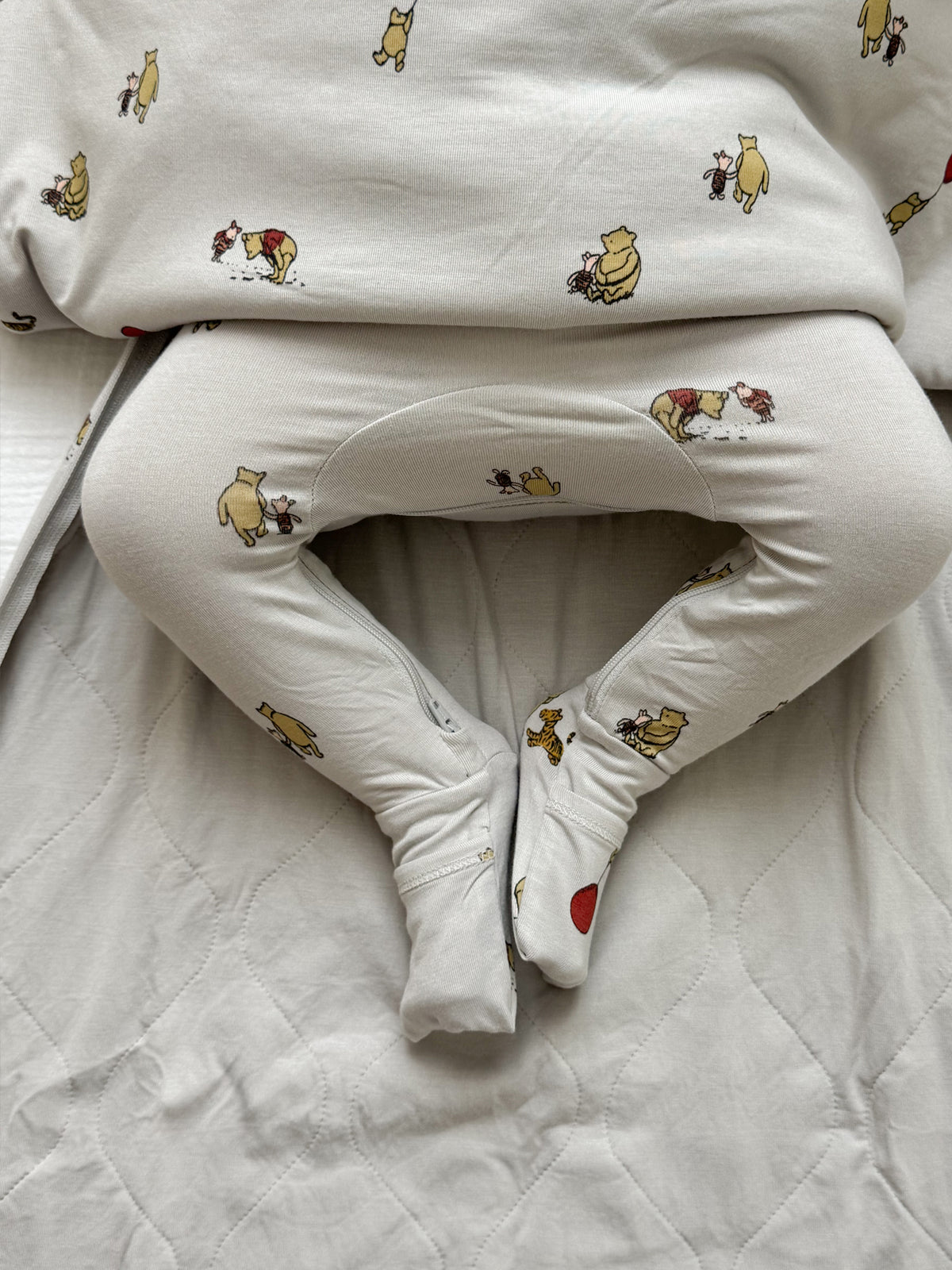 White baby sleep sack with Pooh character print and wide leg openings