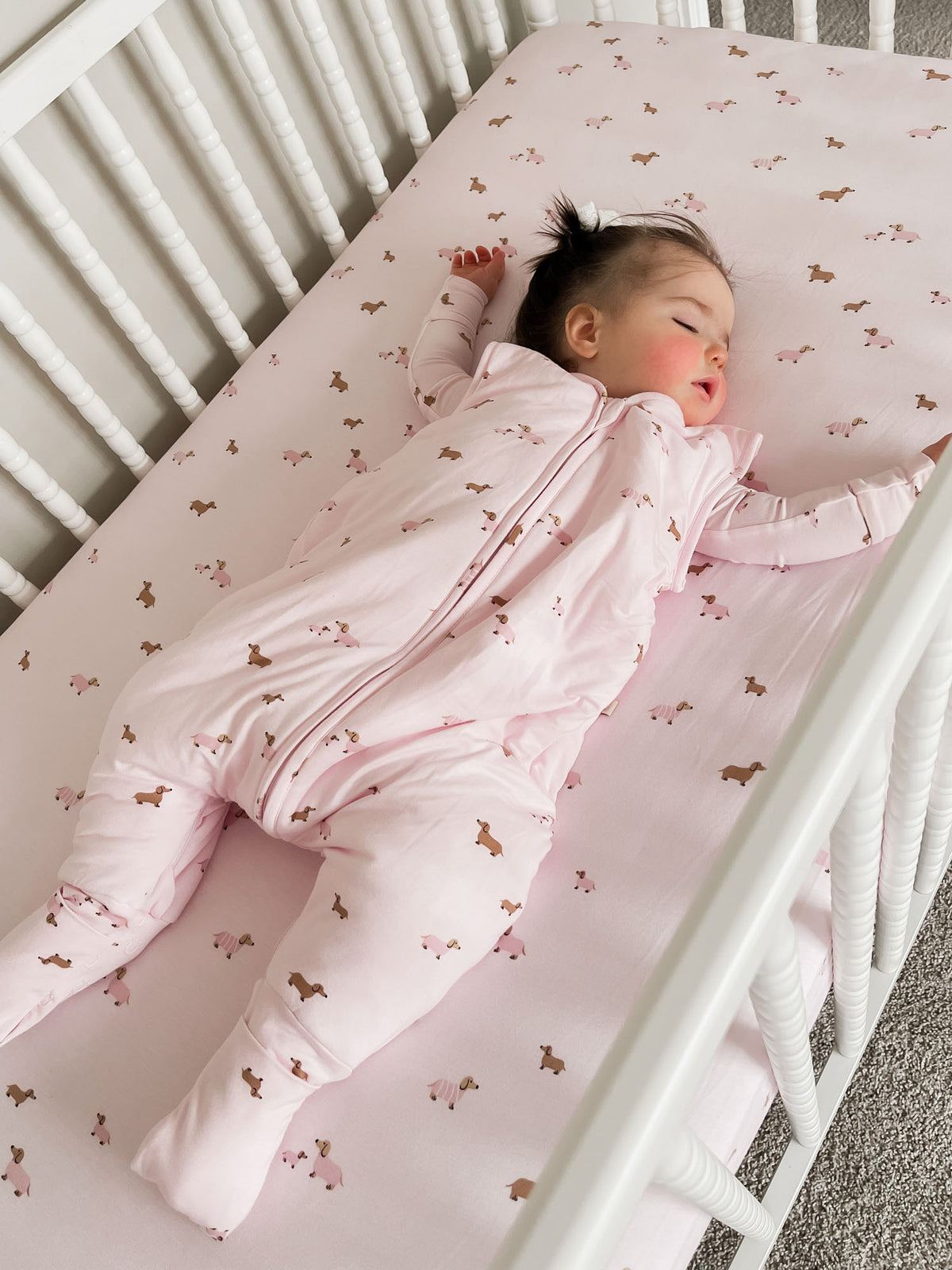 Light pink dog-print footie sleep sack with full zipper and covered legs