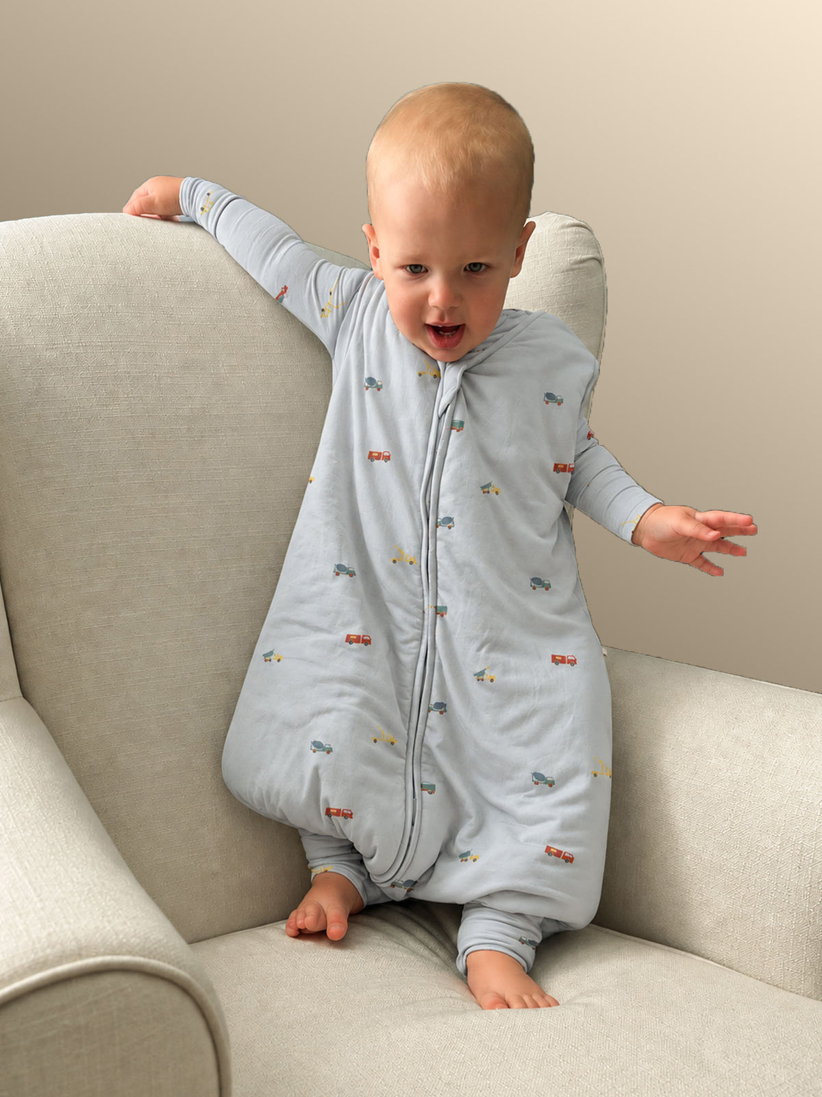 Light blue footie sleep sack with small vehicle print and front zipper