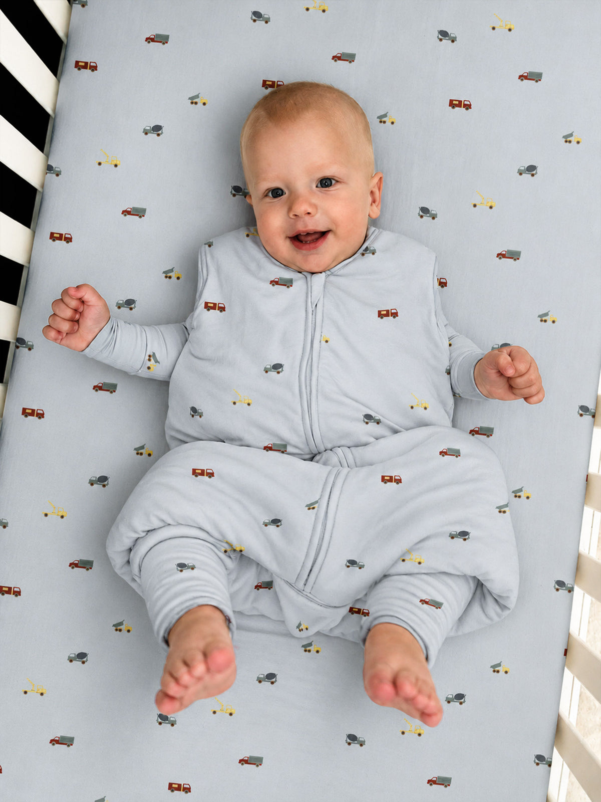 Light blue footie sleep sack with vehicle pattern, two-way zipper, enclosed feet